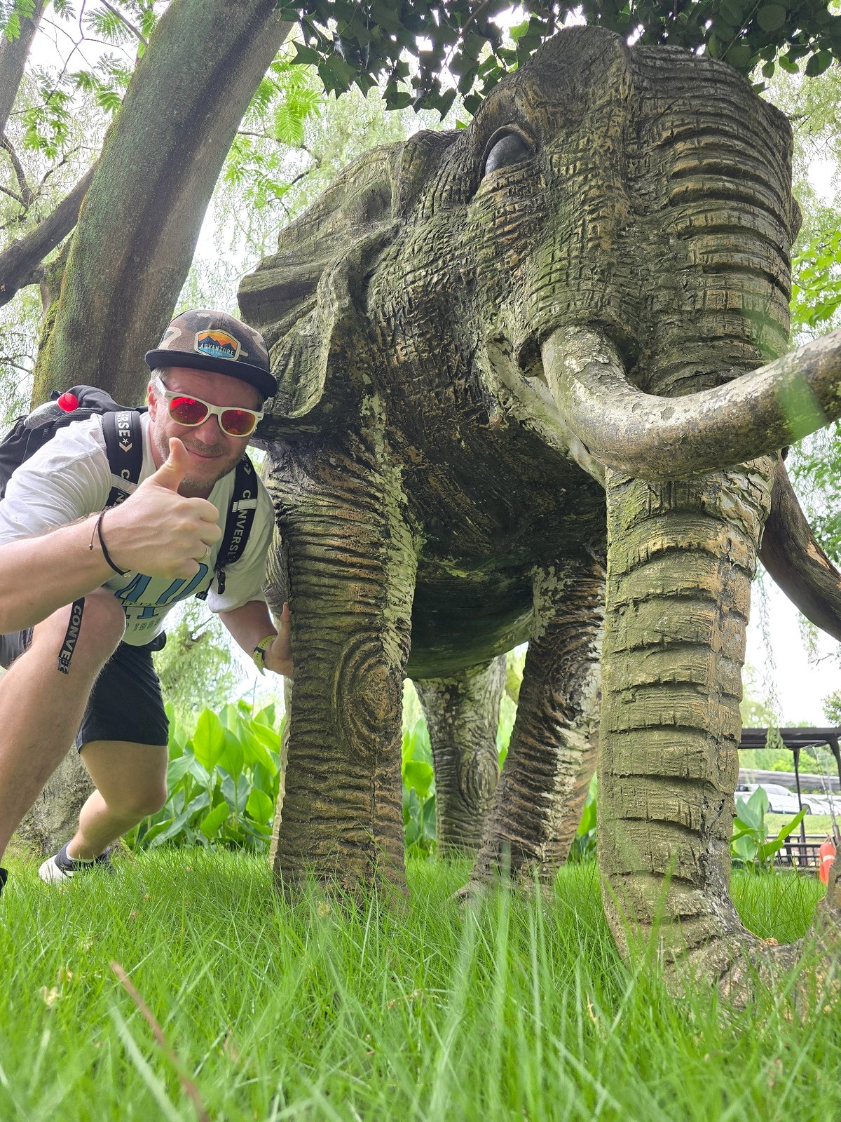 Tourist poses with elephant statue in Xihu District
