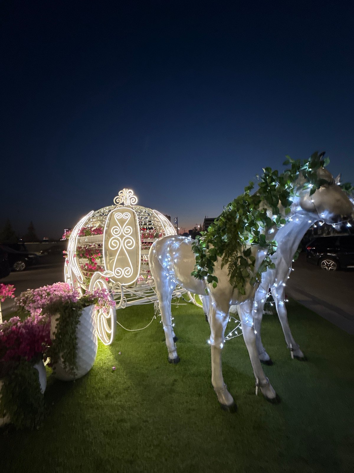 Evening at Kazan's Riviera Hotel: lights, rides, and ornate decor