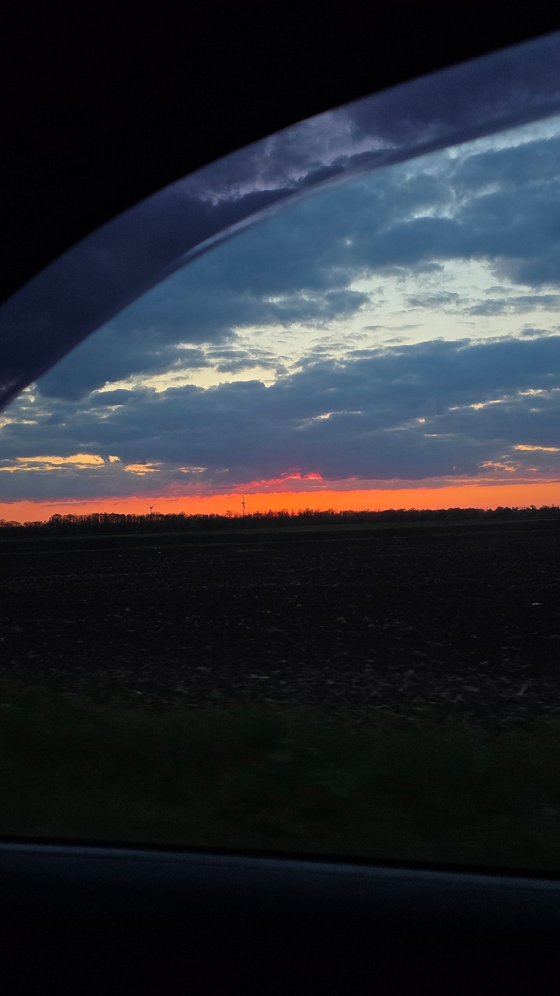 Dramatic sunset observed over rural Kavarna landscape from vehicle
