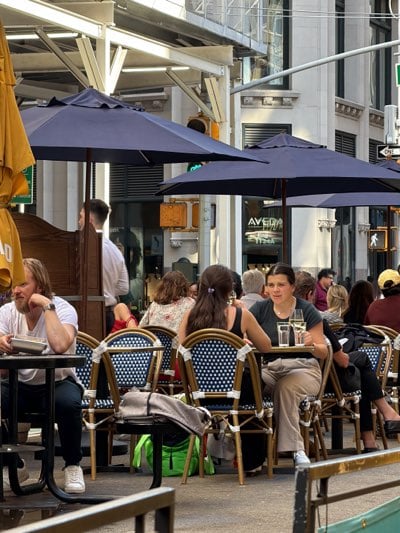 NYC outdoor dining scene captured during evening hours