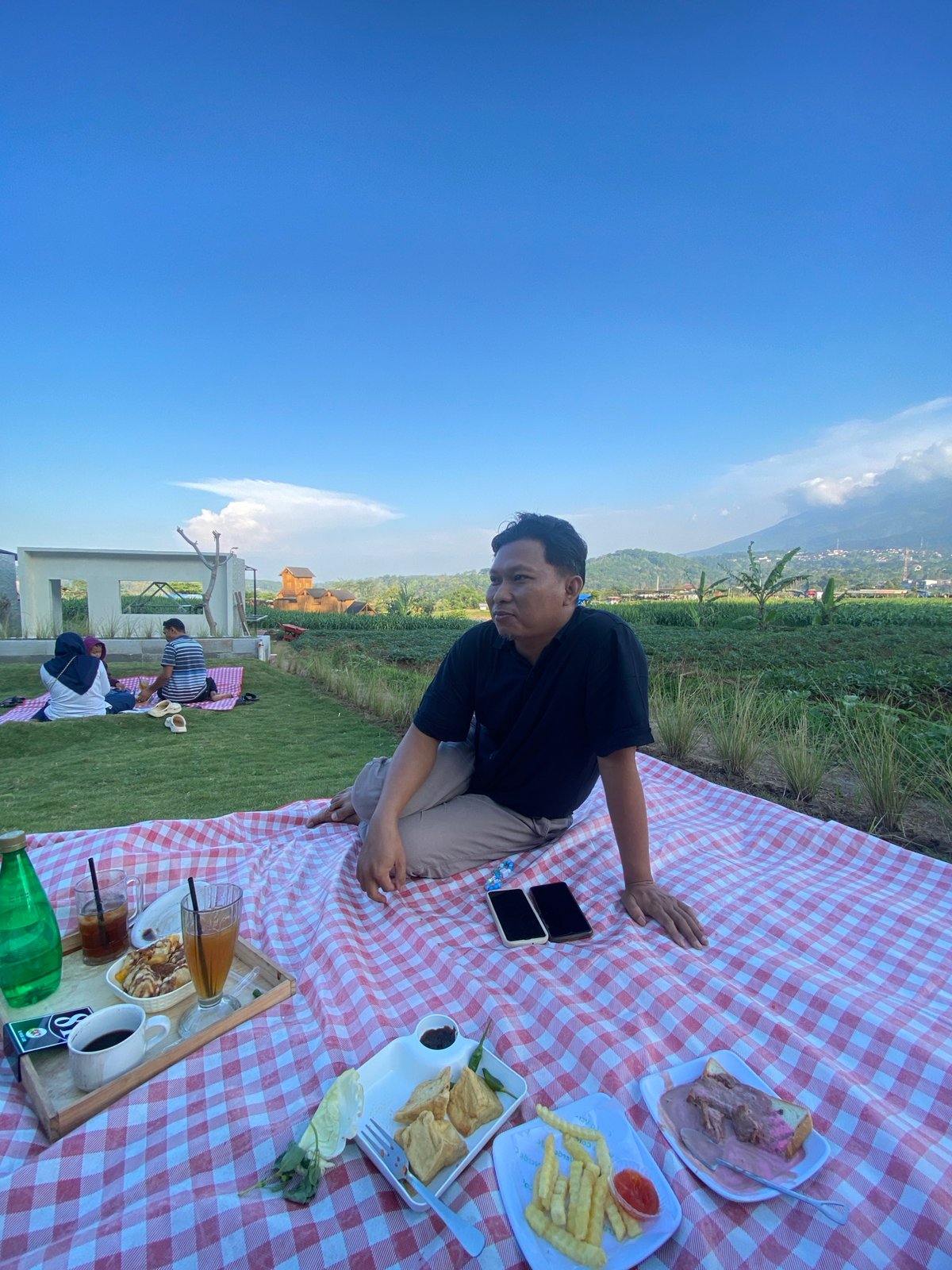 Family picnic on terraced farmland in Kesiman, Indonesia