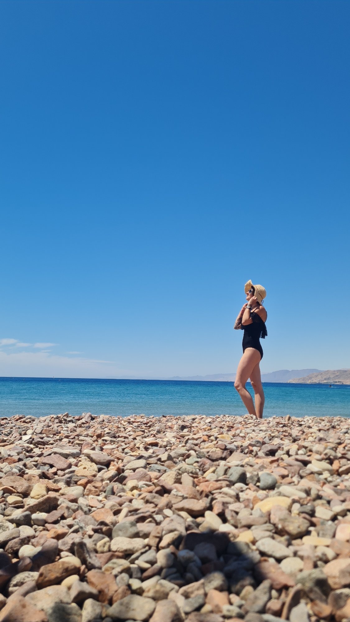 Woman enjoys morning beach moments in Eilat, Israel