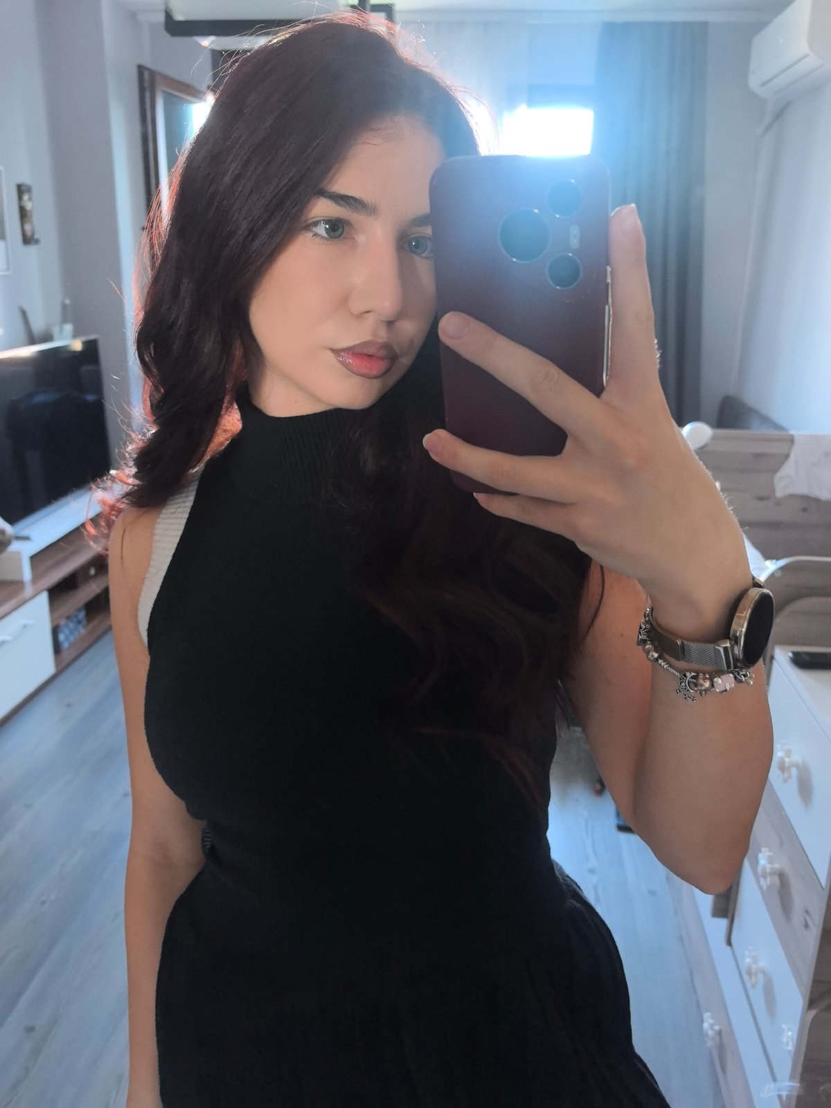 Woman Takes Early Morning Selfies in Black Turtleneck