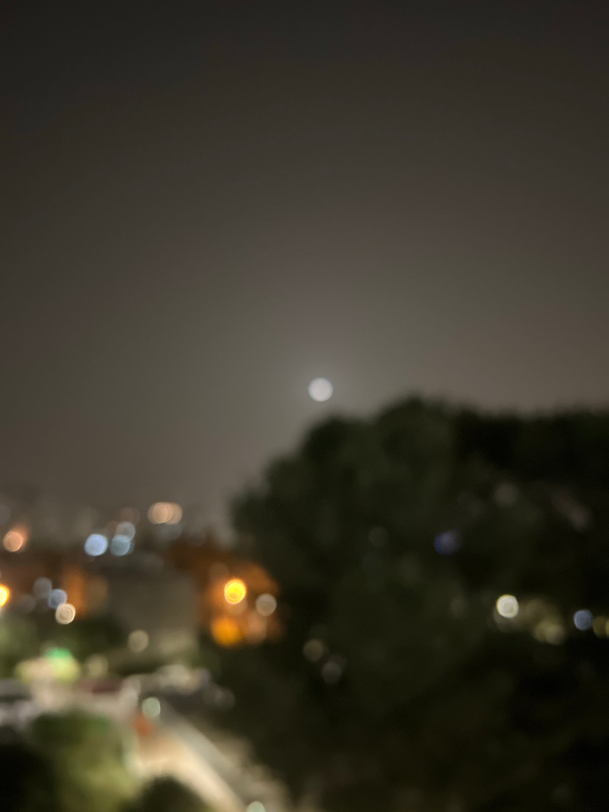 Nearly full moon observed over Kiryat Bialik nightscape