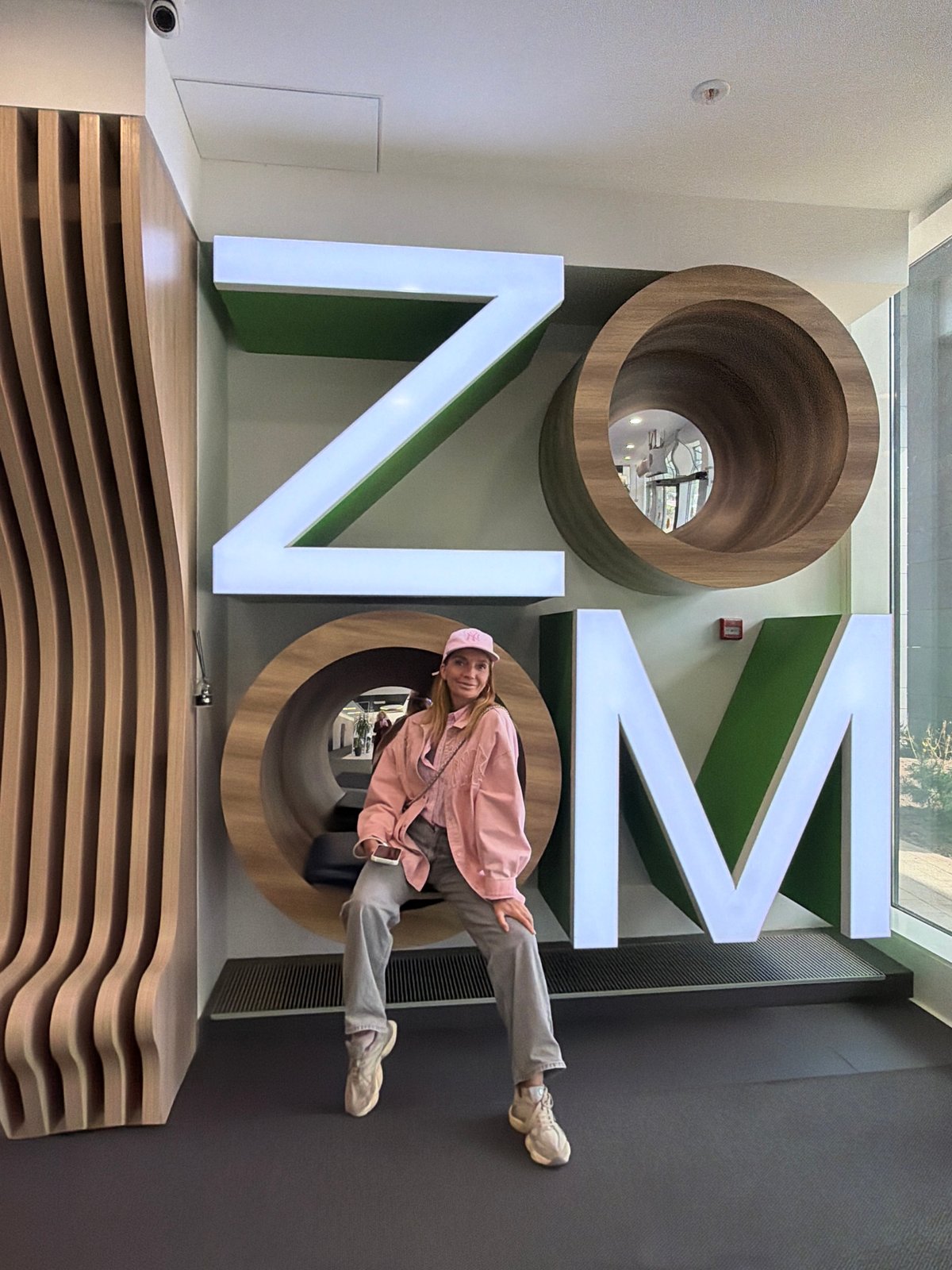 Woman poses with interactive letter art at Saint Petersburg hotel