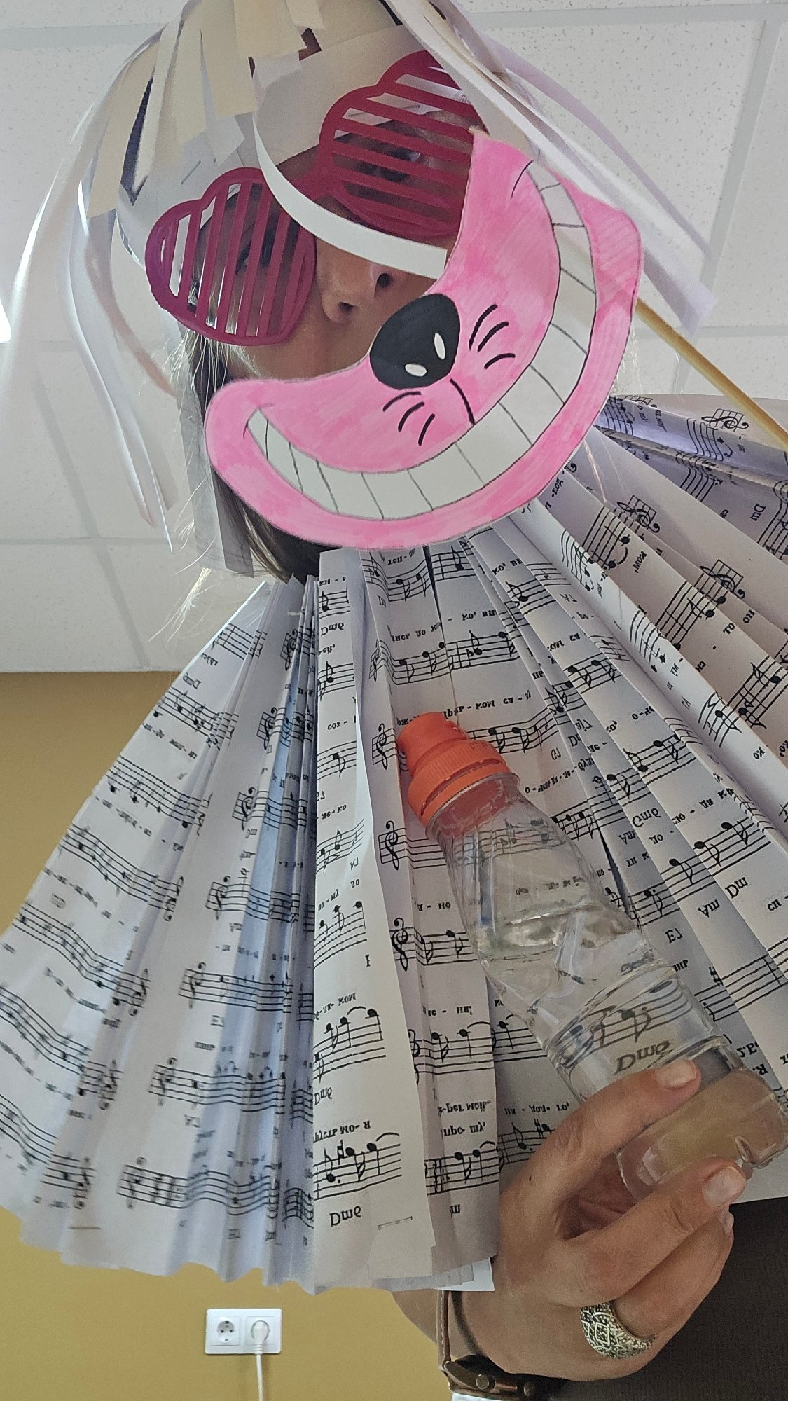 Costume party participants wear handmade outfits with cat masks