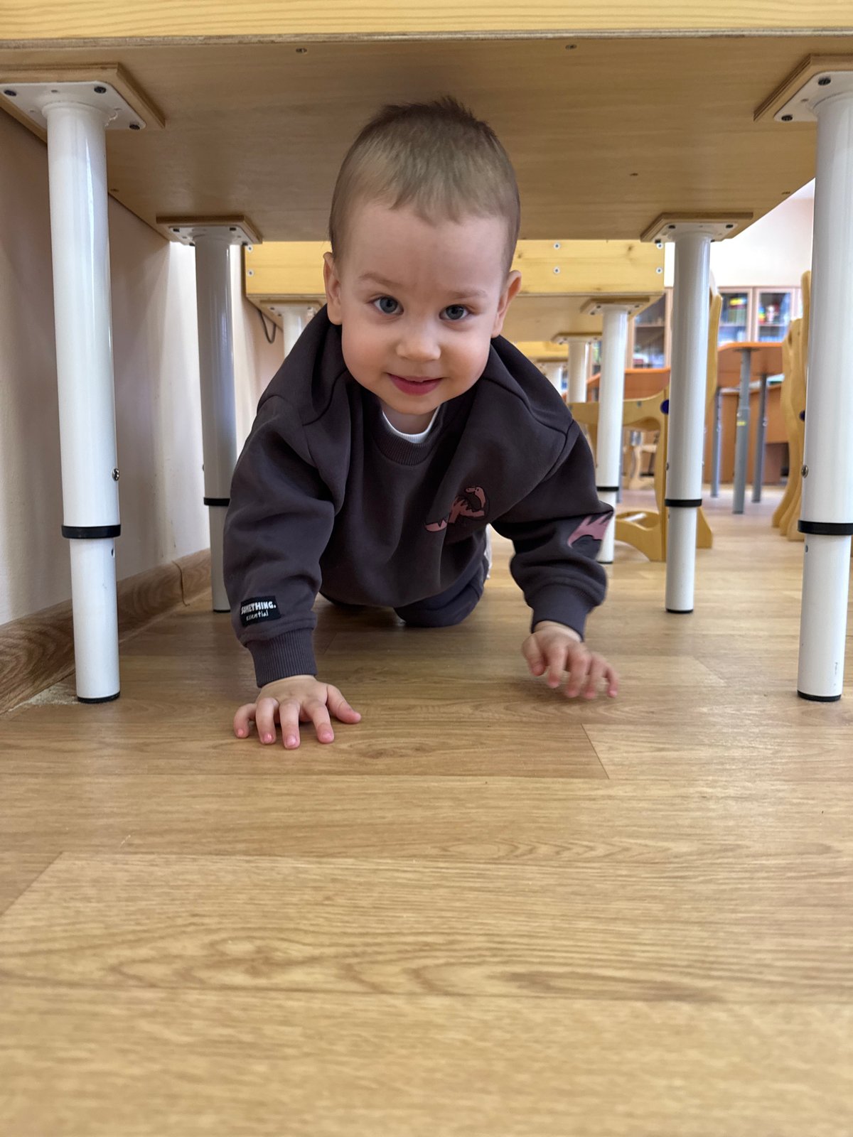 Children play indoors with wooden toys in Rusanovo