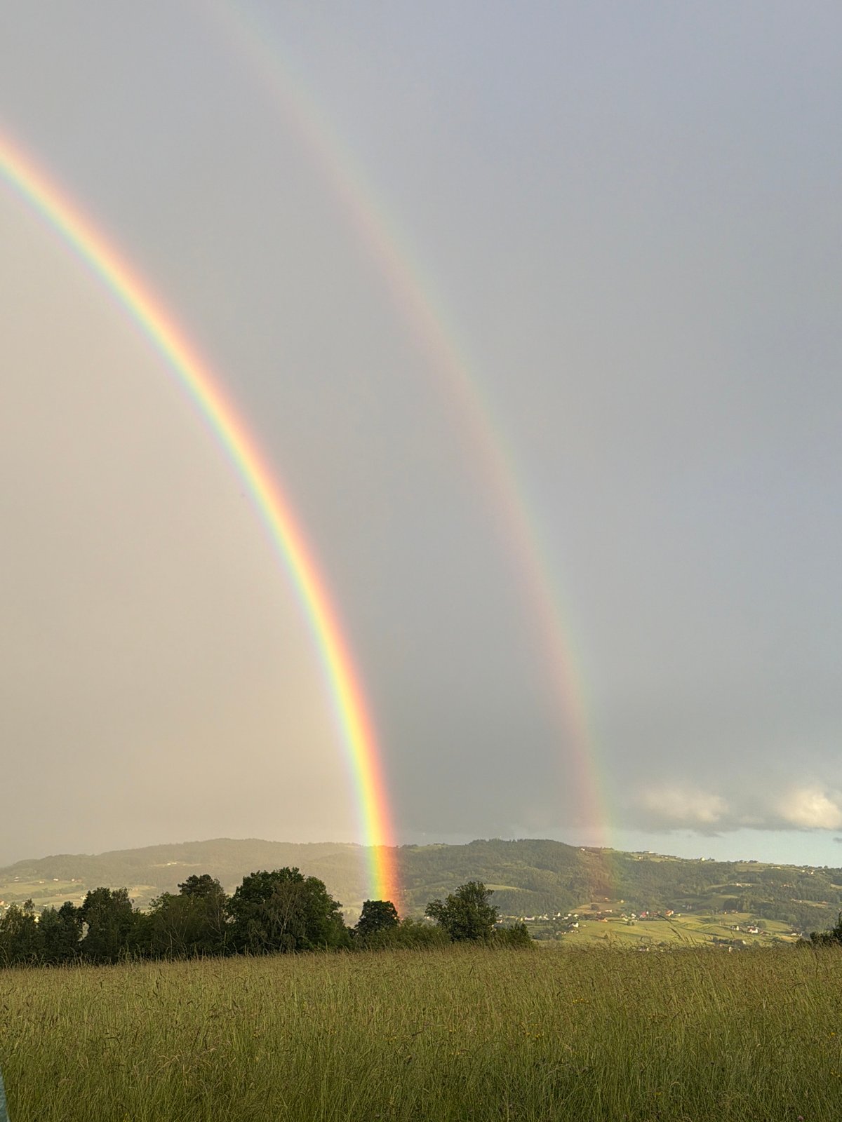 Double rainbow appears over Męcina village, Poland