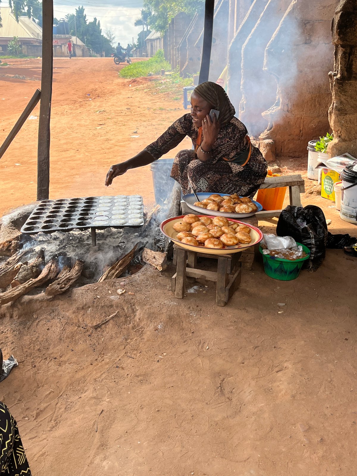 A moment at a Lafia market stall, phone in hand