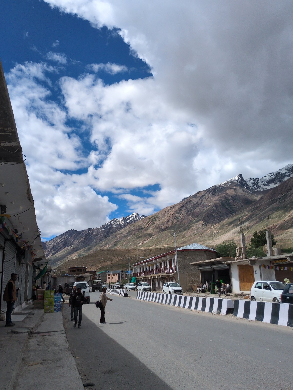 Padum street scene with dramatic Himalayan peaks behind