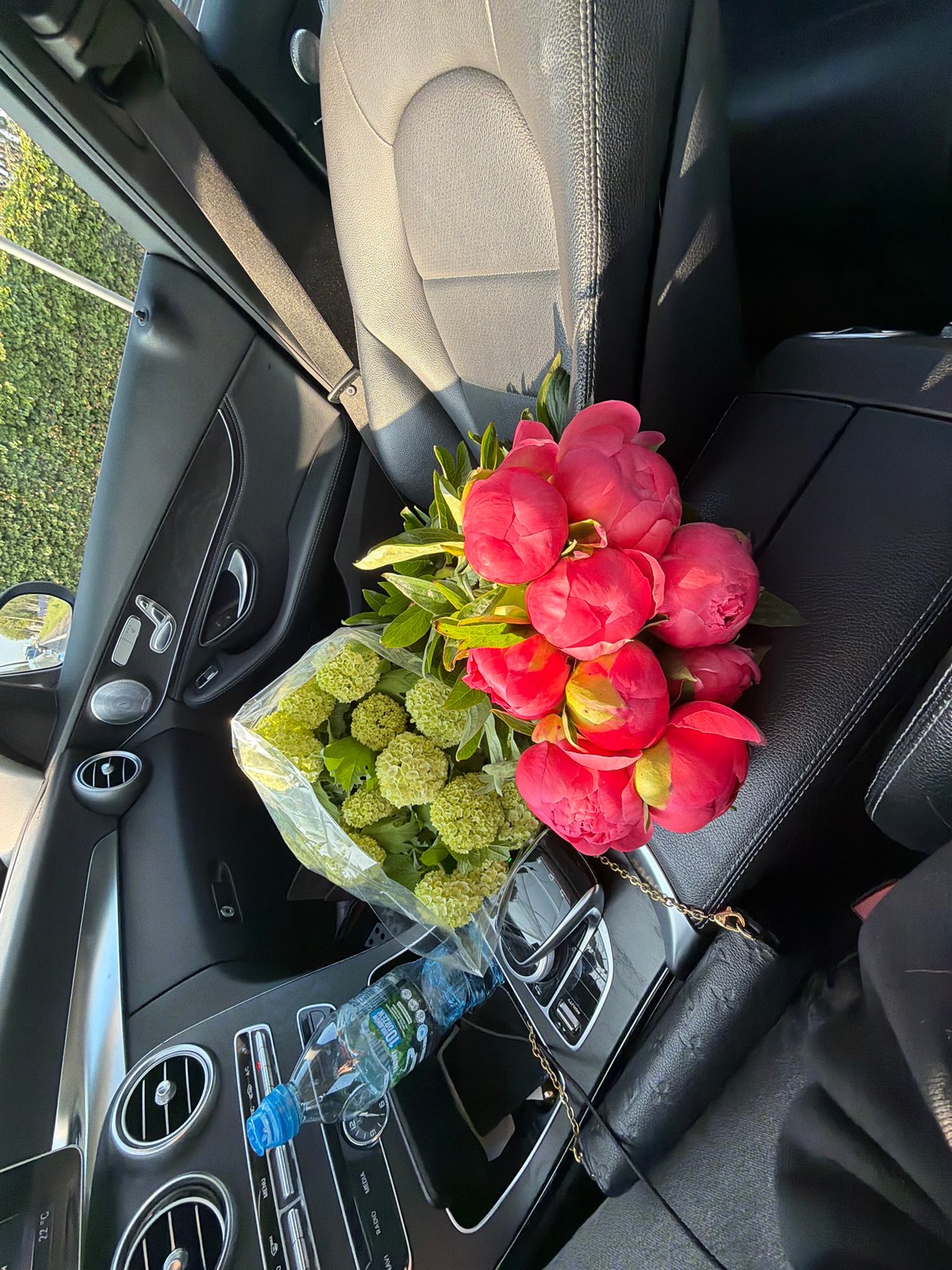 Woman documents flower bouquet journey from elevator to car