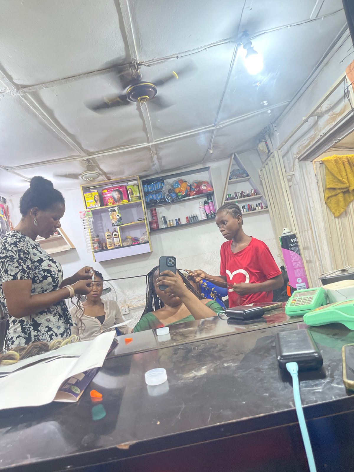 Hair salon operations documented in Abuja during evening hours