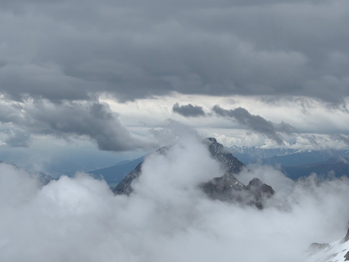 Heavy fog shrouds Zugspitze glacier with snowcats operating