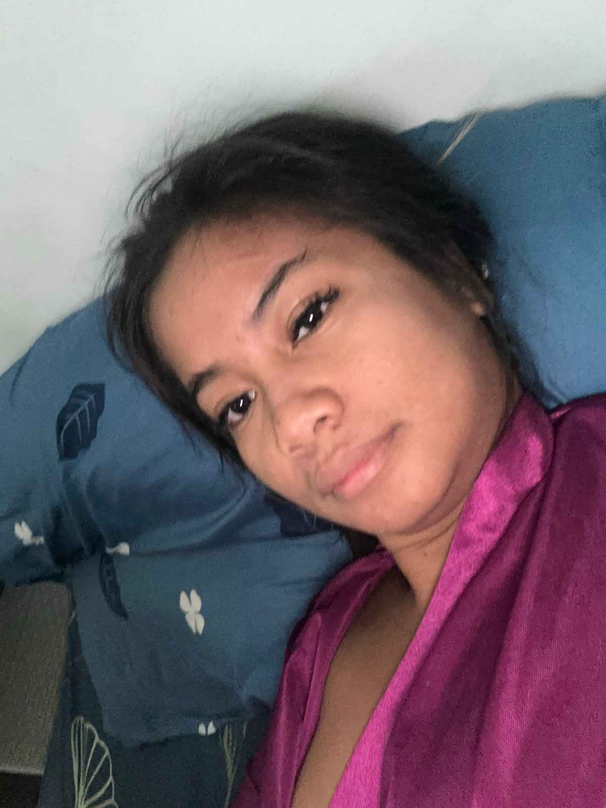 Woman enjoys lazy morning with desserts and cat in Sukawati bedroom