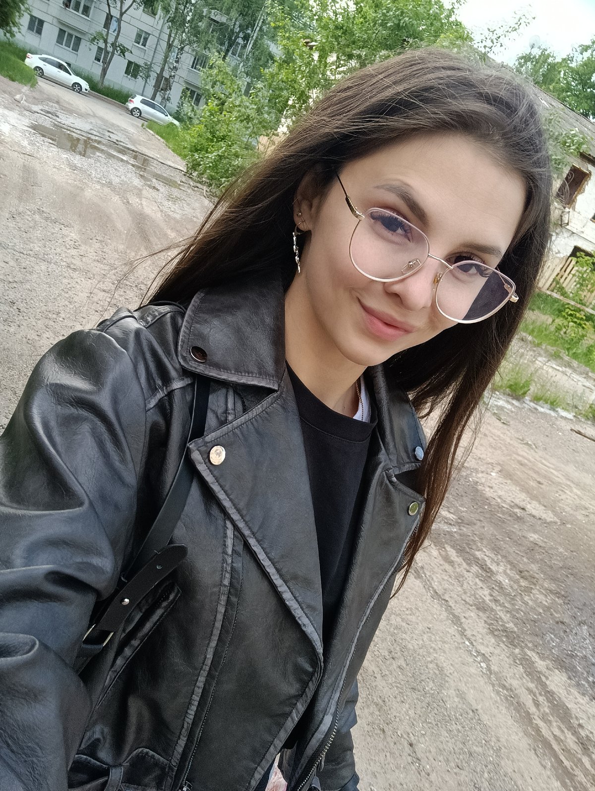 Woman takes outdoor selfies with lollipop, child nearby