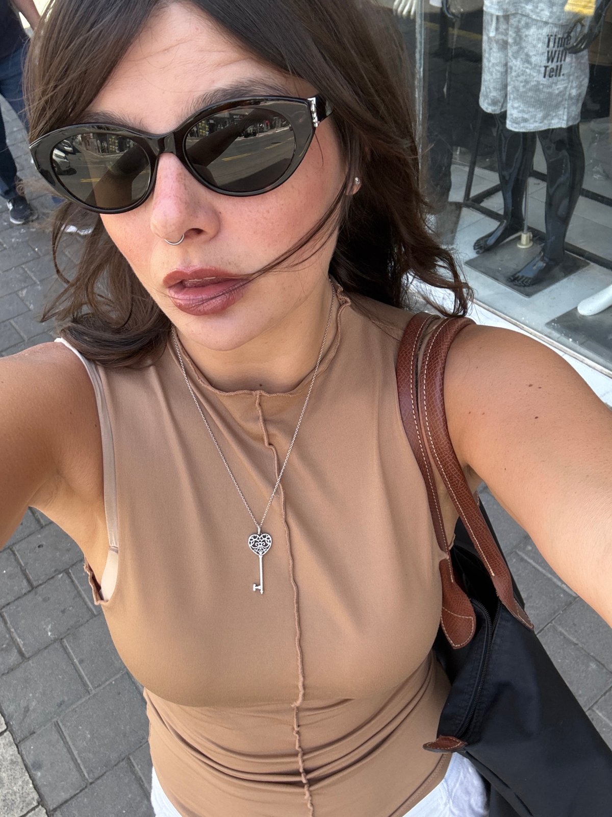 Tourist takes multiple selfies on Tel-Aviv street