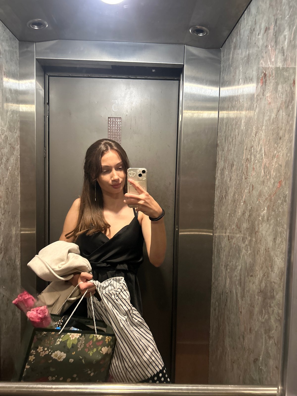 Woman takes elevator selfie with shopping bags in Burgas