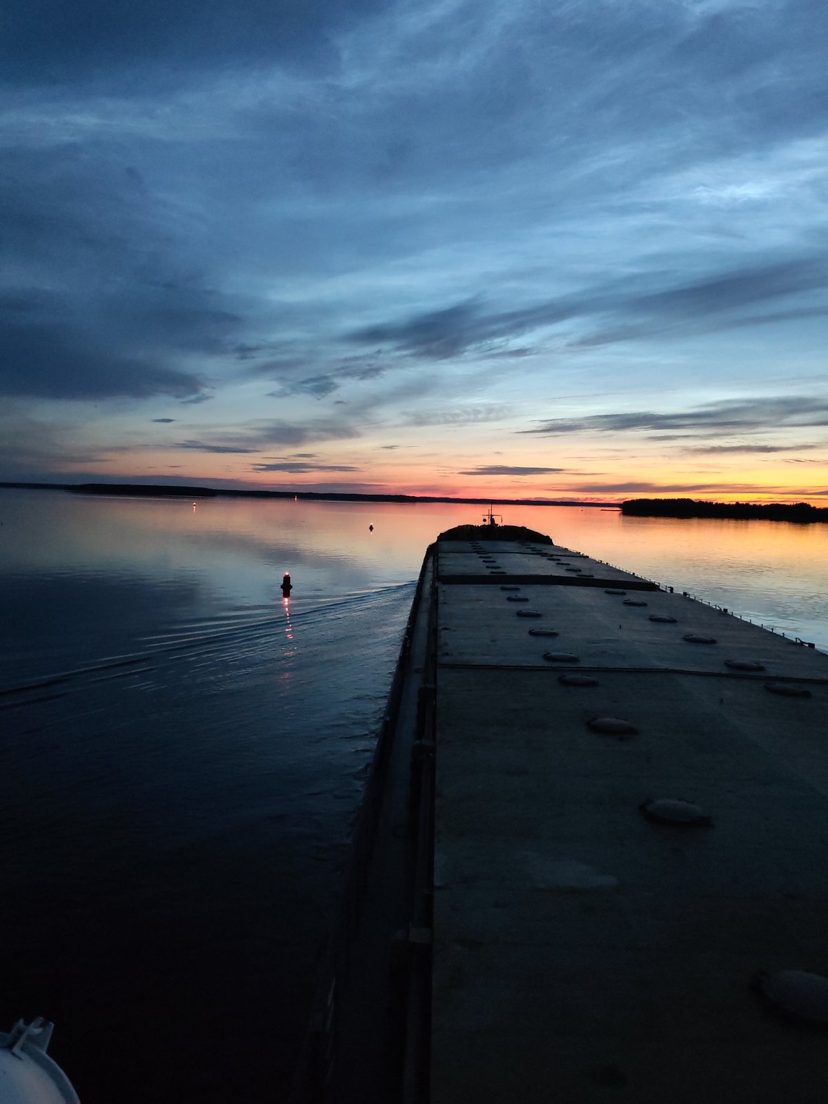 Sunset to moonrise on the Sheksna River, barge in frame