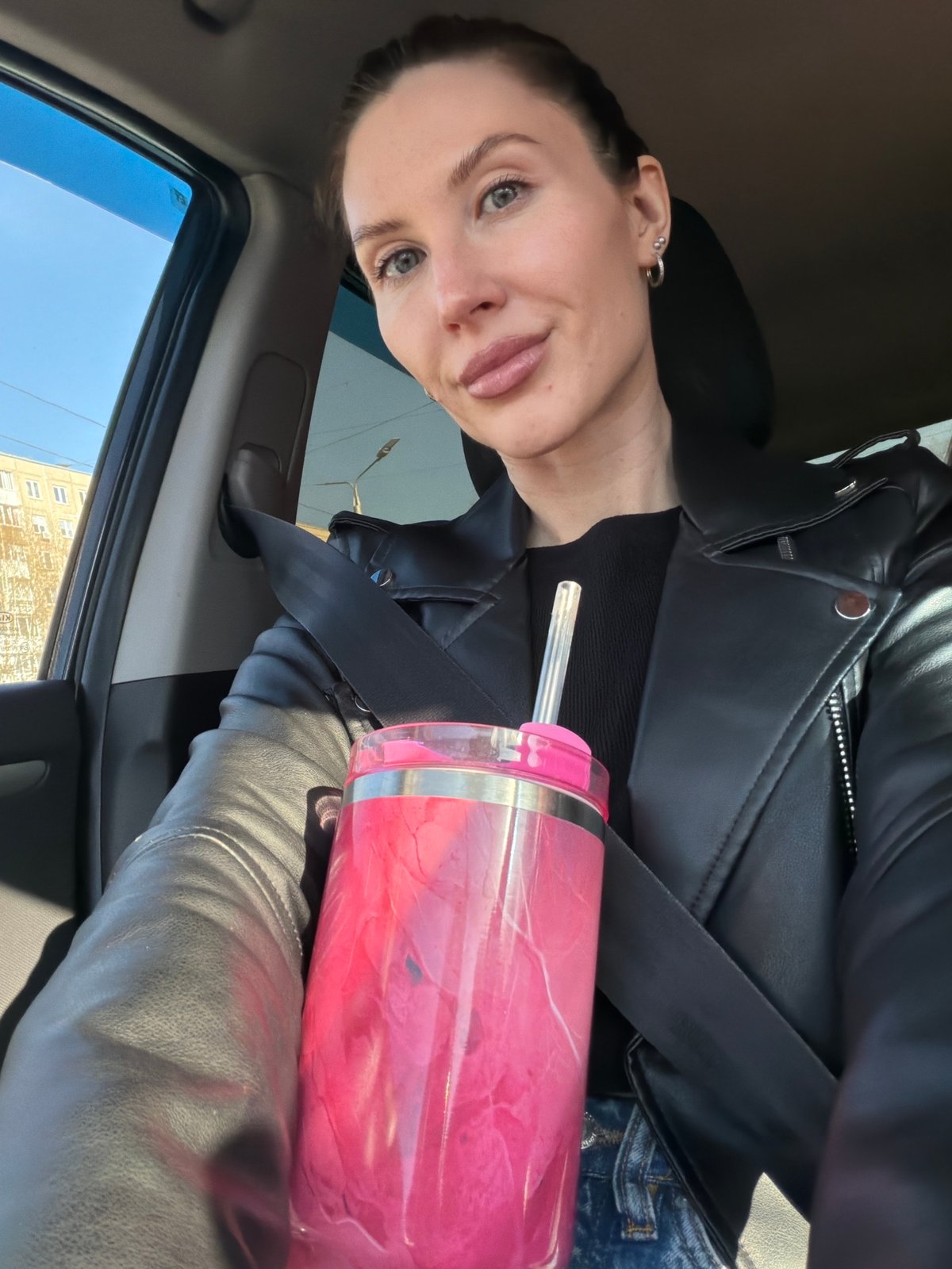 Driver secures pink tumbler with seatbelt in Perm