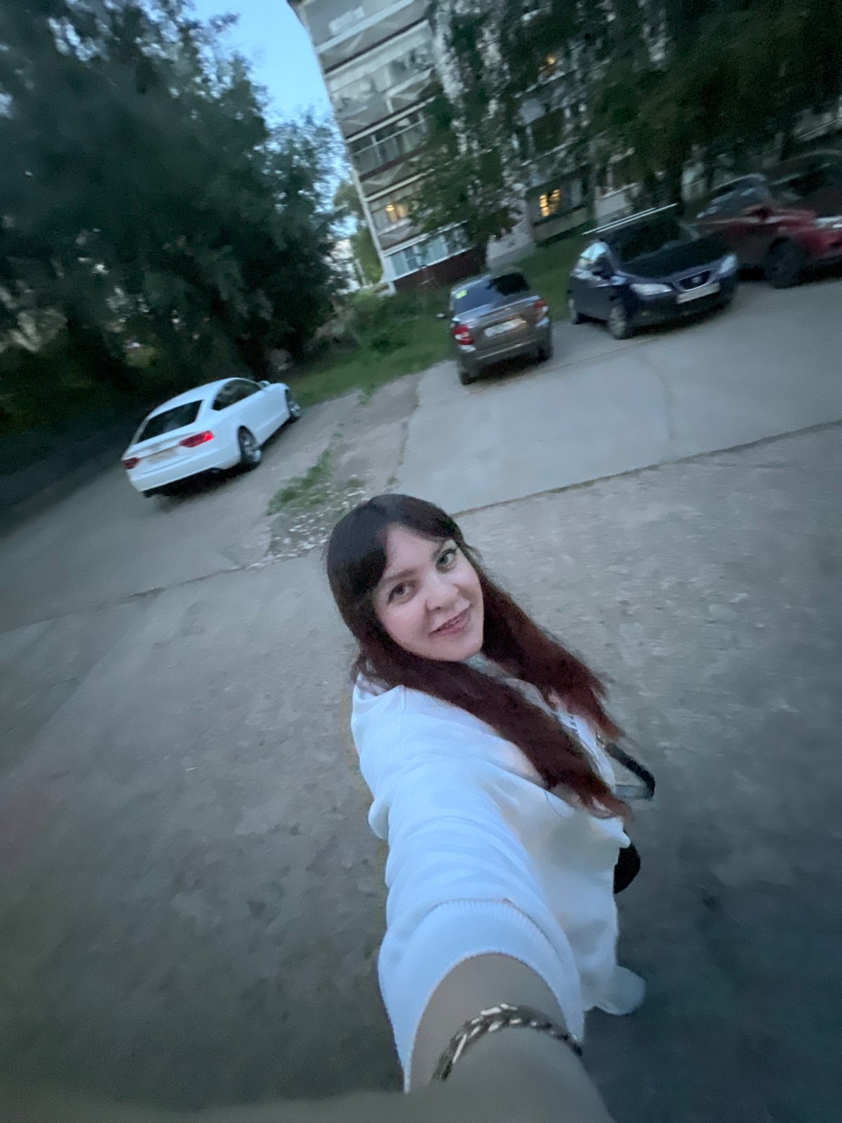 Residents document evening street life in Noviy, Russia