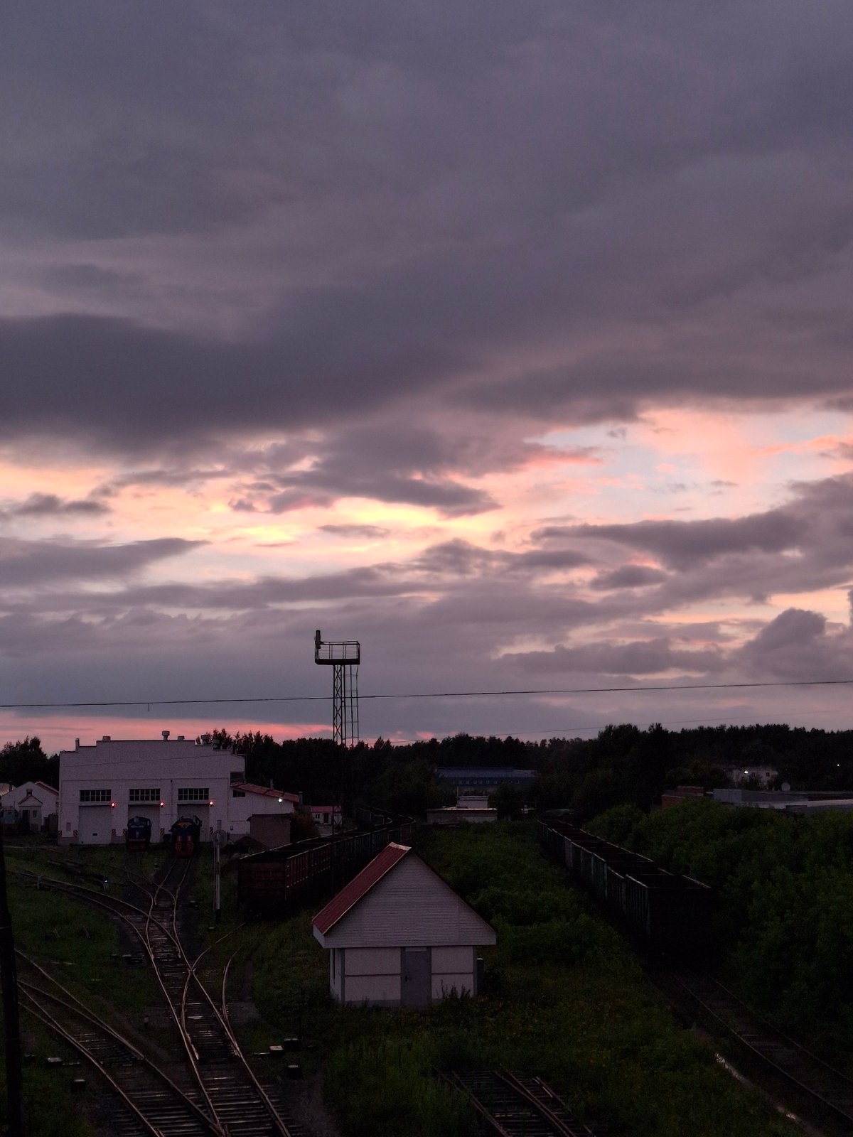 Rainy dusk settles over Chaikovsky's streets and rail yard