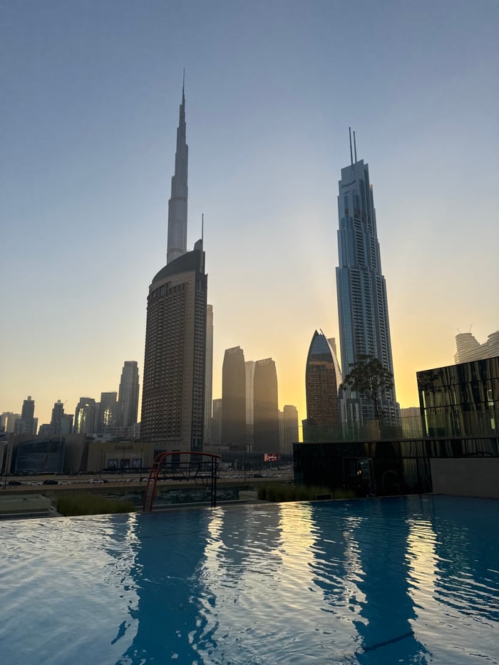 Witness captures golden hour Dubai skyline from rooftop pool