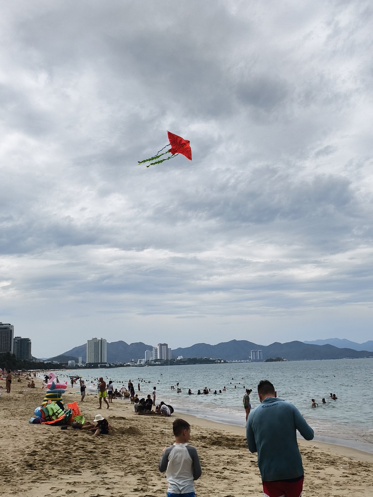 Overcast morning beach scenes with kite flying documented