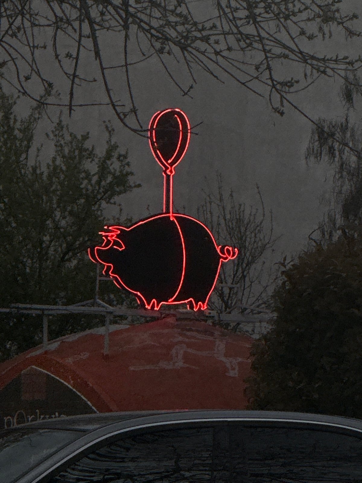 Neon pig balloon sign spotted on Plovdiv building