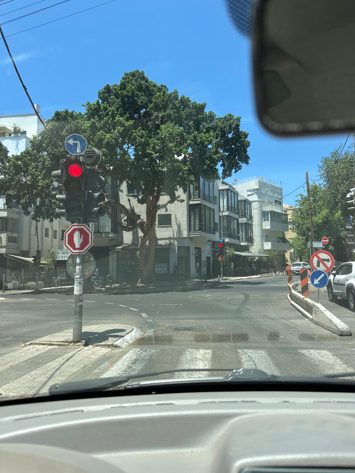 Red light at a Tel Aviv intersection, viewed from inside a car