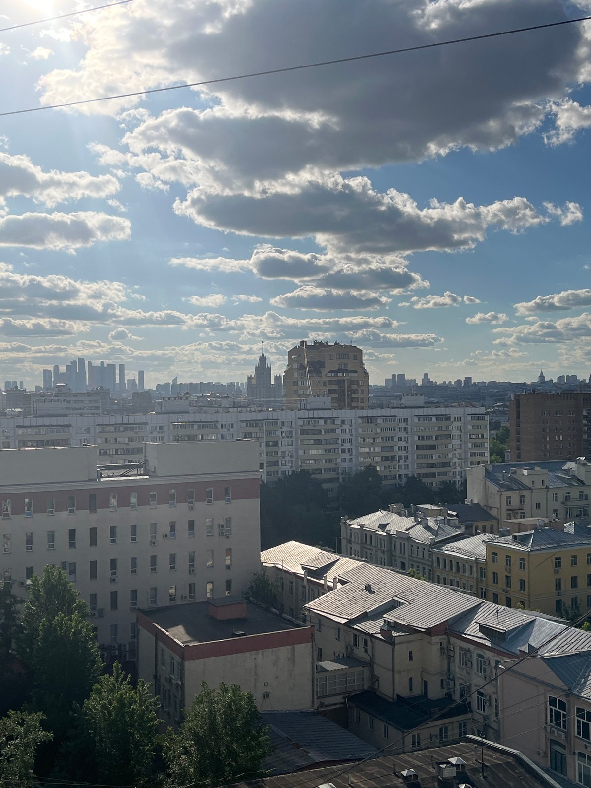 Cityscape viewed from elevated position under partly cloudy skies