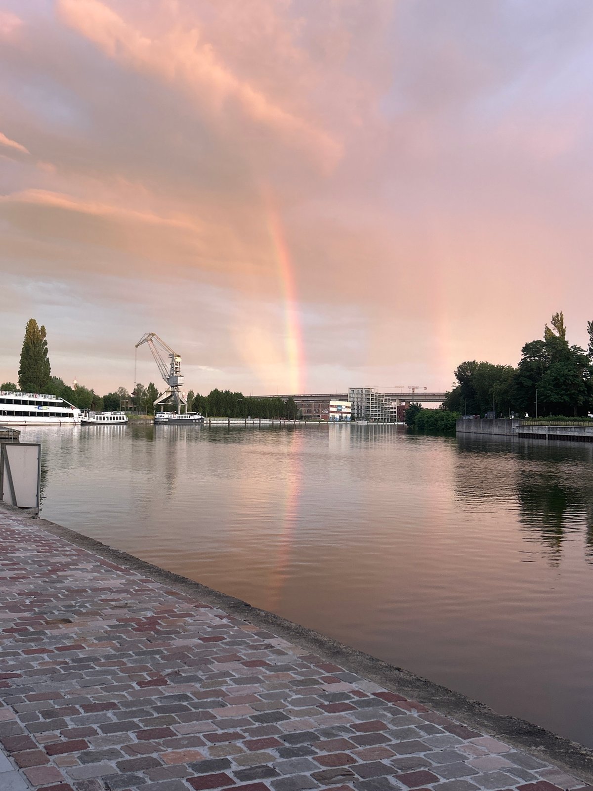 Double rainbow over Vilvoorde canal at golden hour