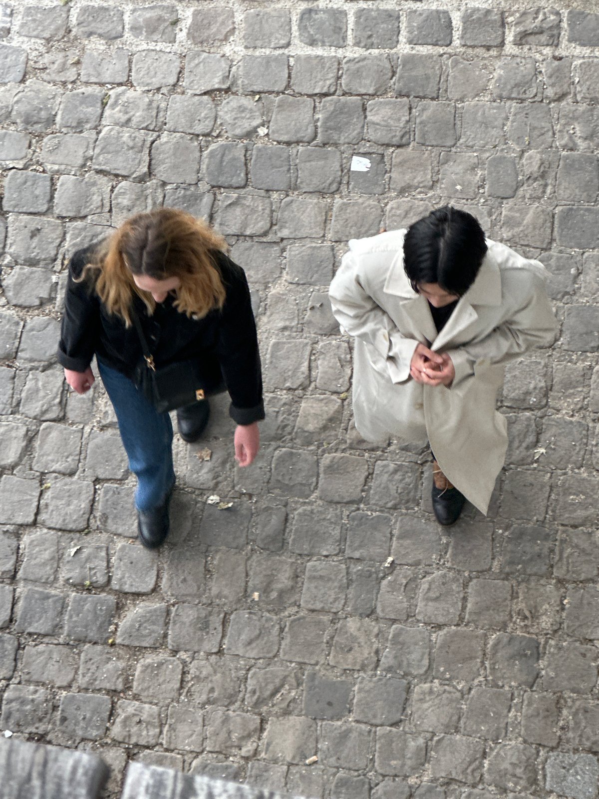 Two women observed on cobblestone street near Paris Panthéon