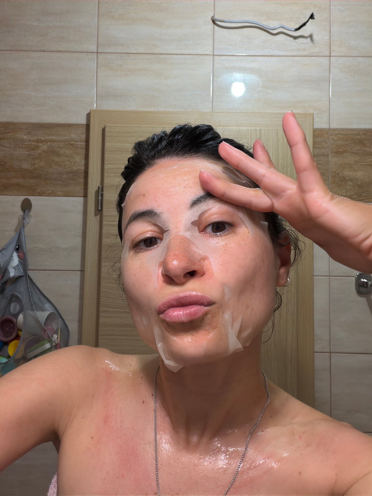 Woman conducts evening skincare routine in Budva bathroom