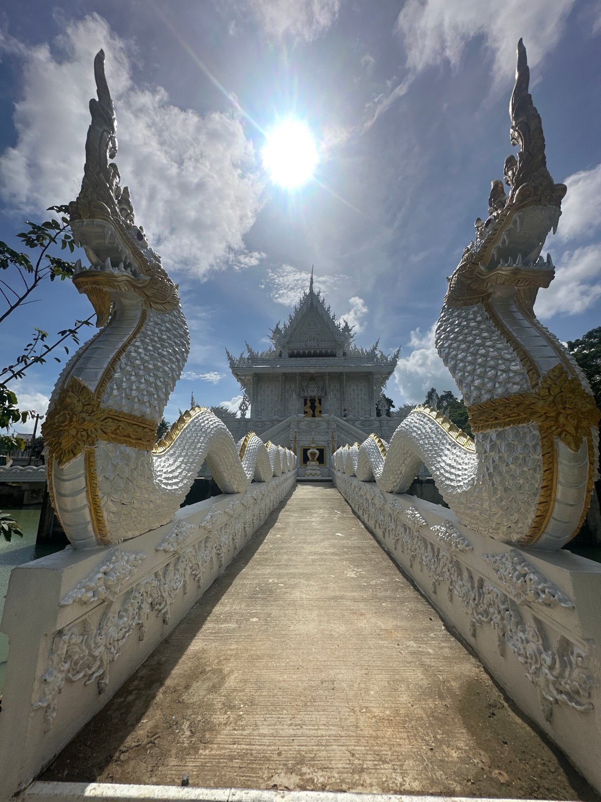 Ornate white temple in Thep Krasatti on a sunny morning
