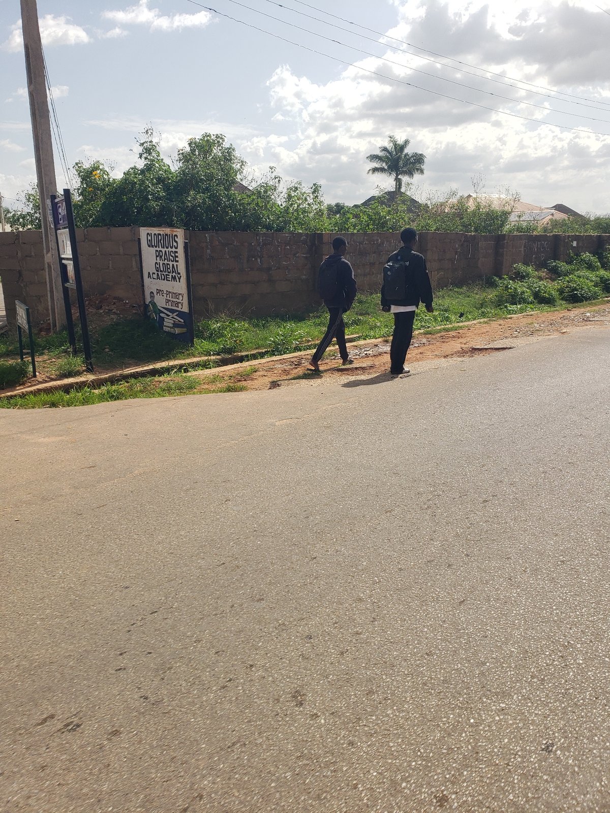 Pedestrians walk through Gura Top neighborhood streets