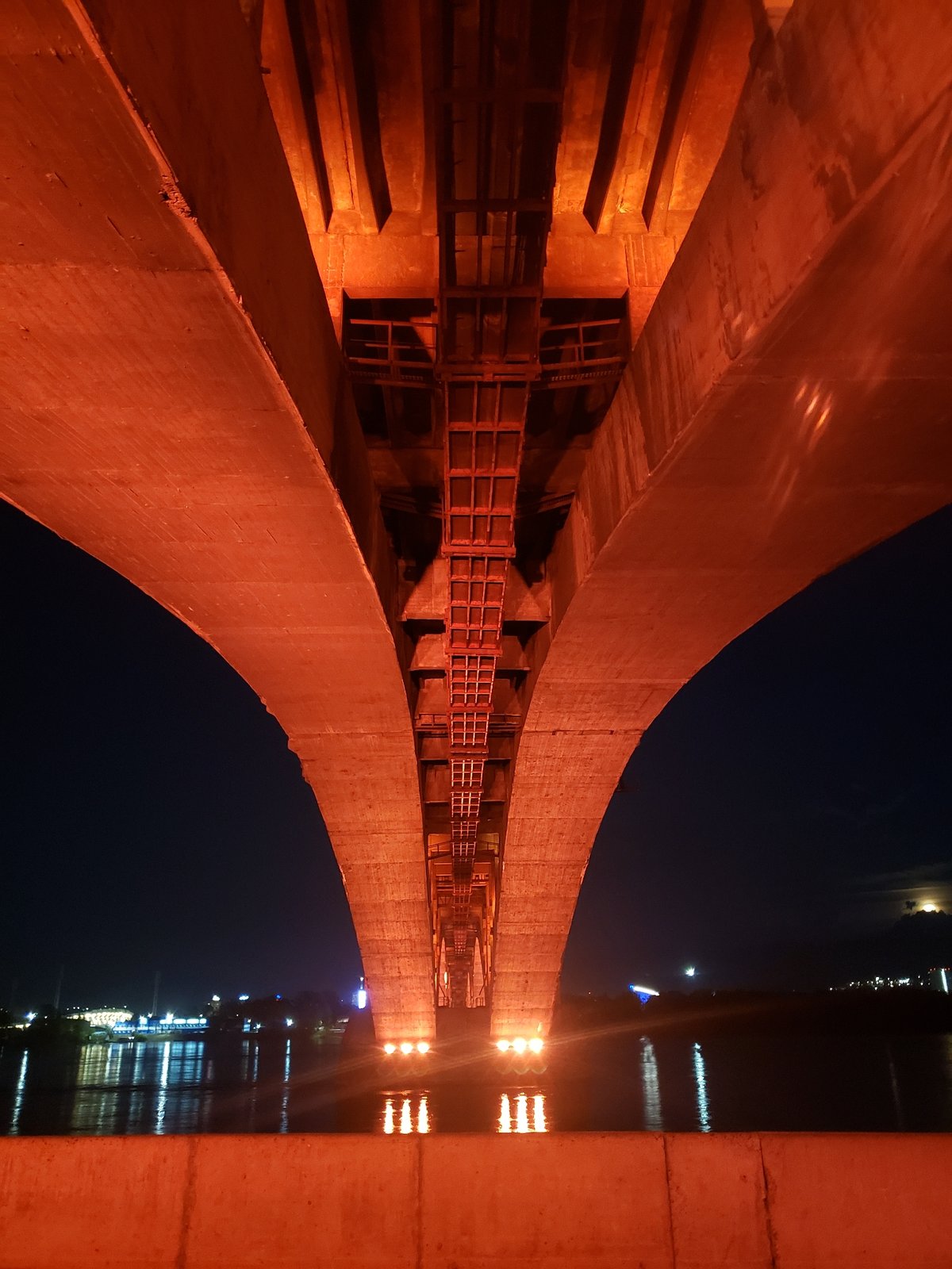 Night out: bridge lights, glowing spheres, and rental scooters