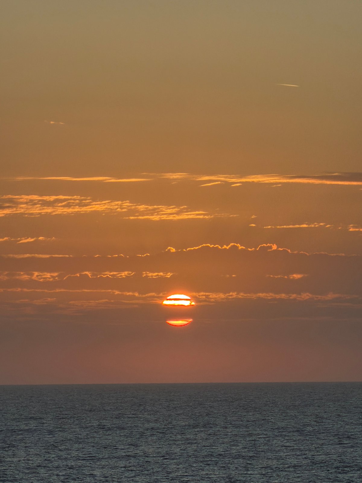Gulf sunset captured with offshore oil platforms visible