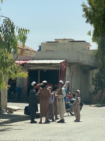 Children gather on Kandahar street corner during morning hours