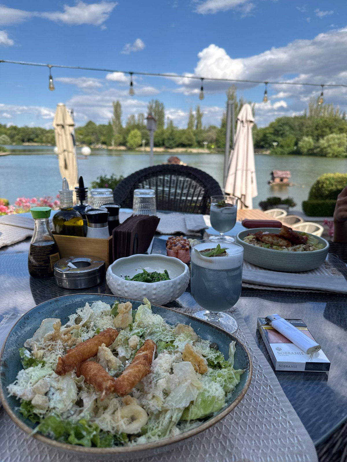 Waterside lunch spread with cocktails and sushi in Bulgaria