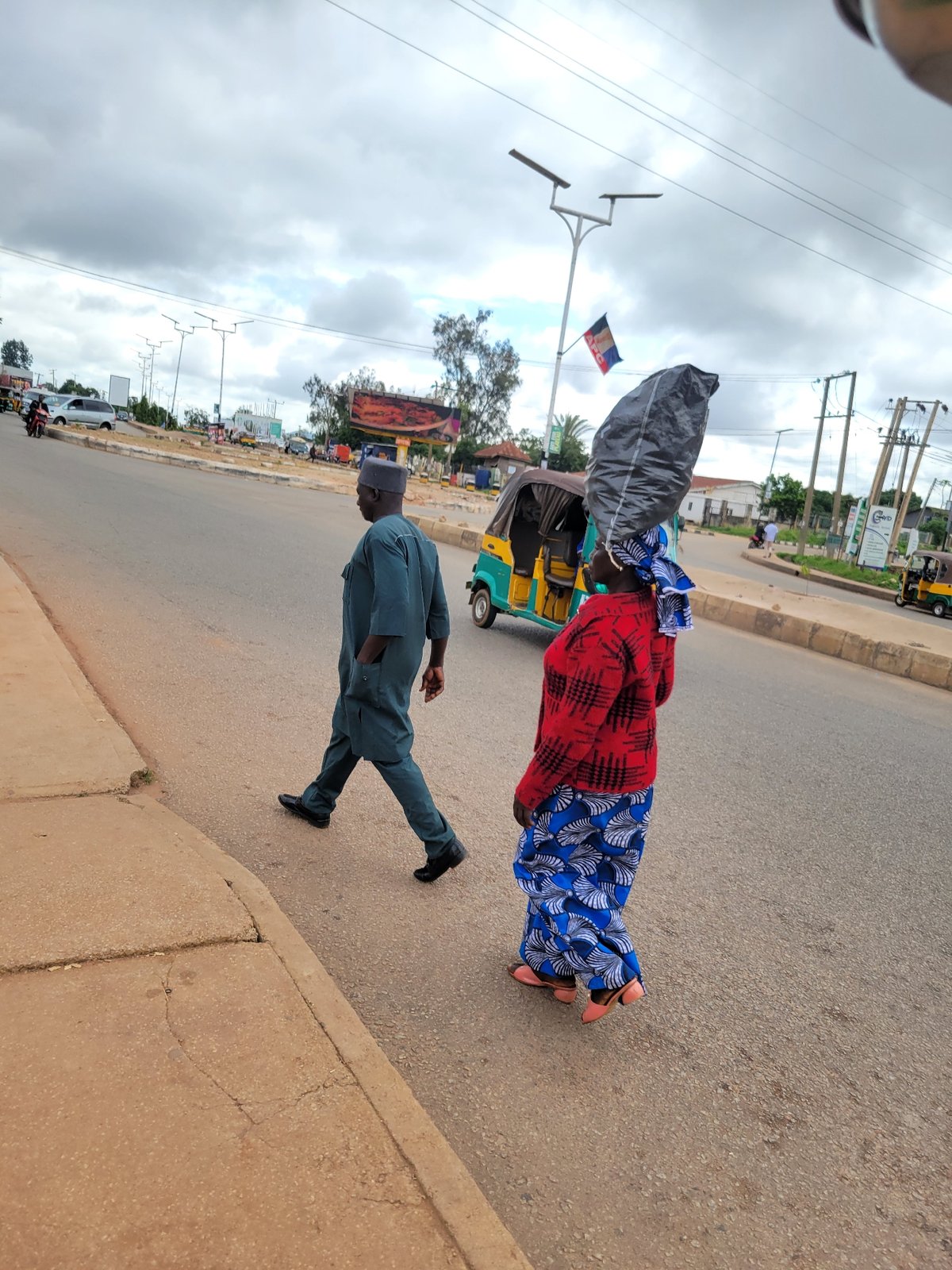 Morning street life and construction activity in Jos, Nigeria