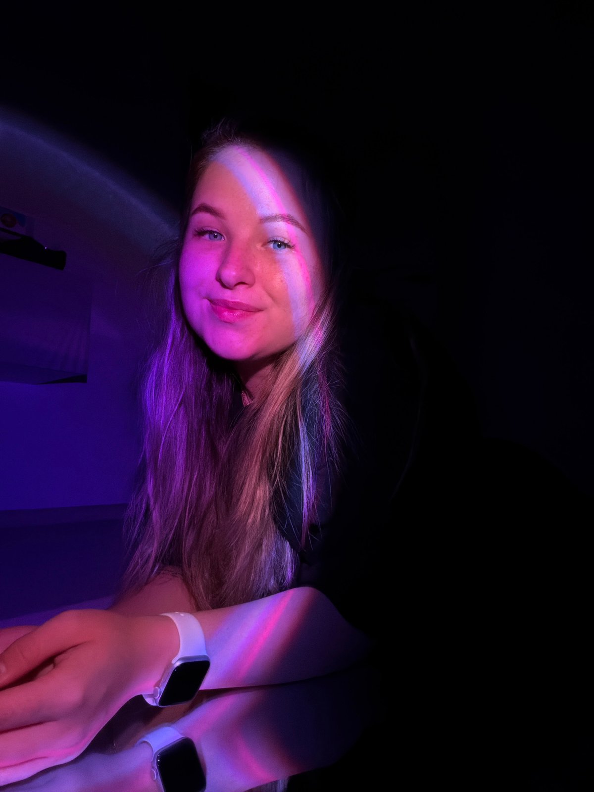 Woman and cat photographed in colorful indoor lighting session