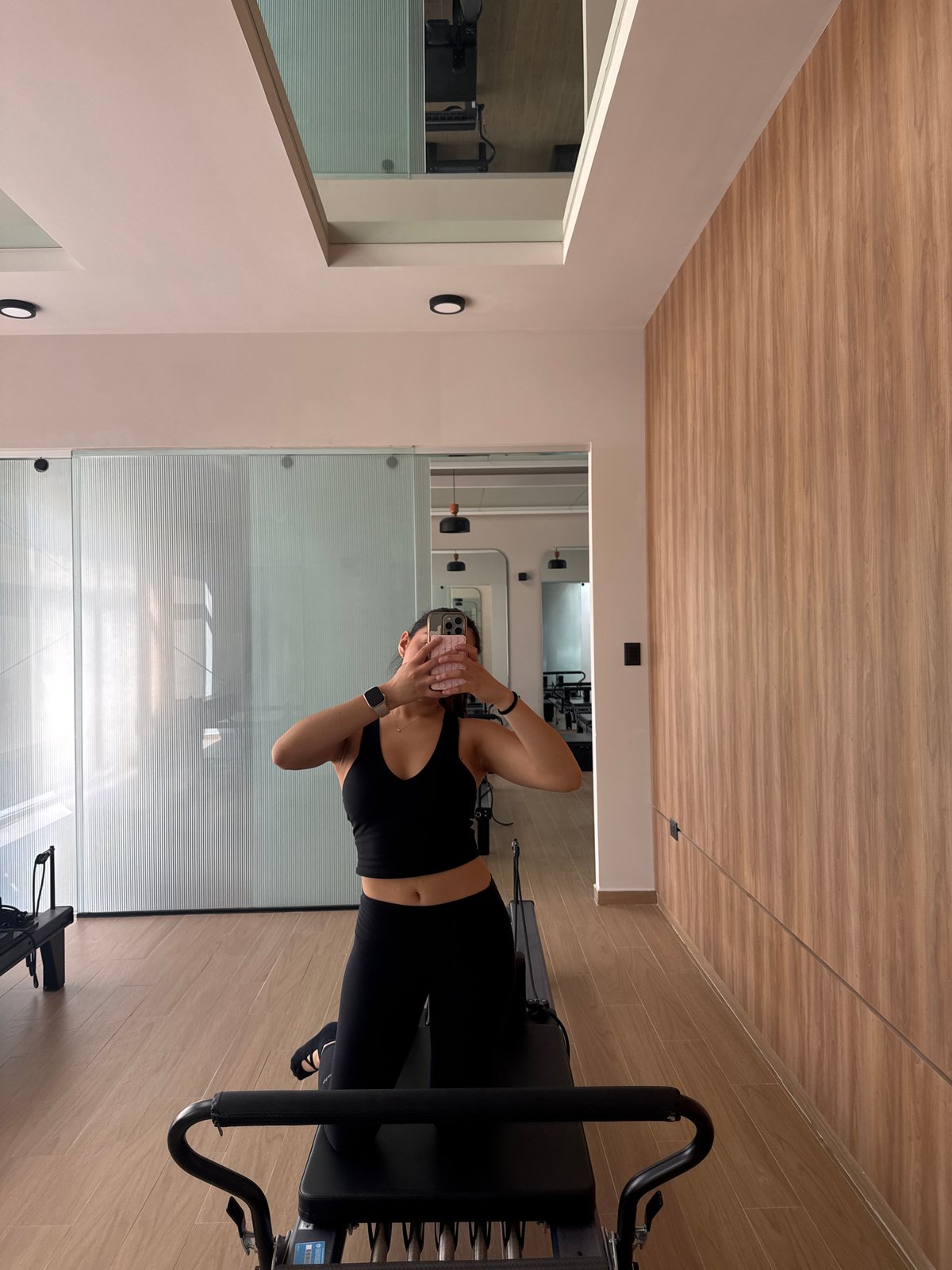 Woman takes mirror selfie at Mexico fitness studio