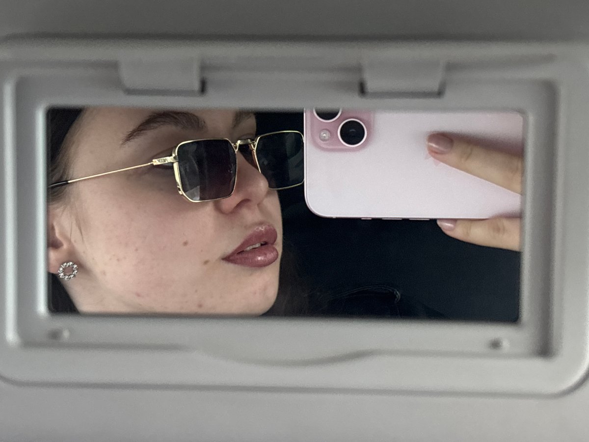 Woman photographed in and around car in Perm, Russia
