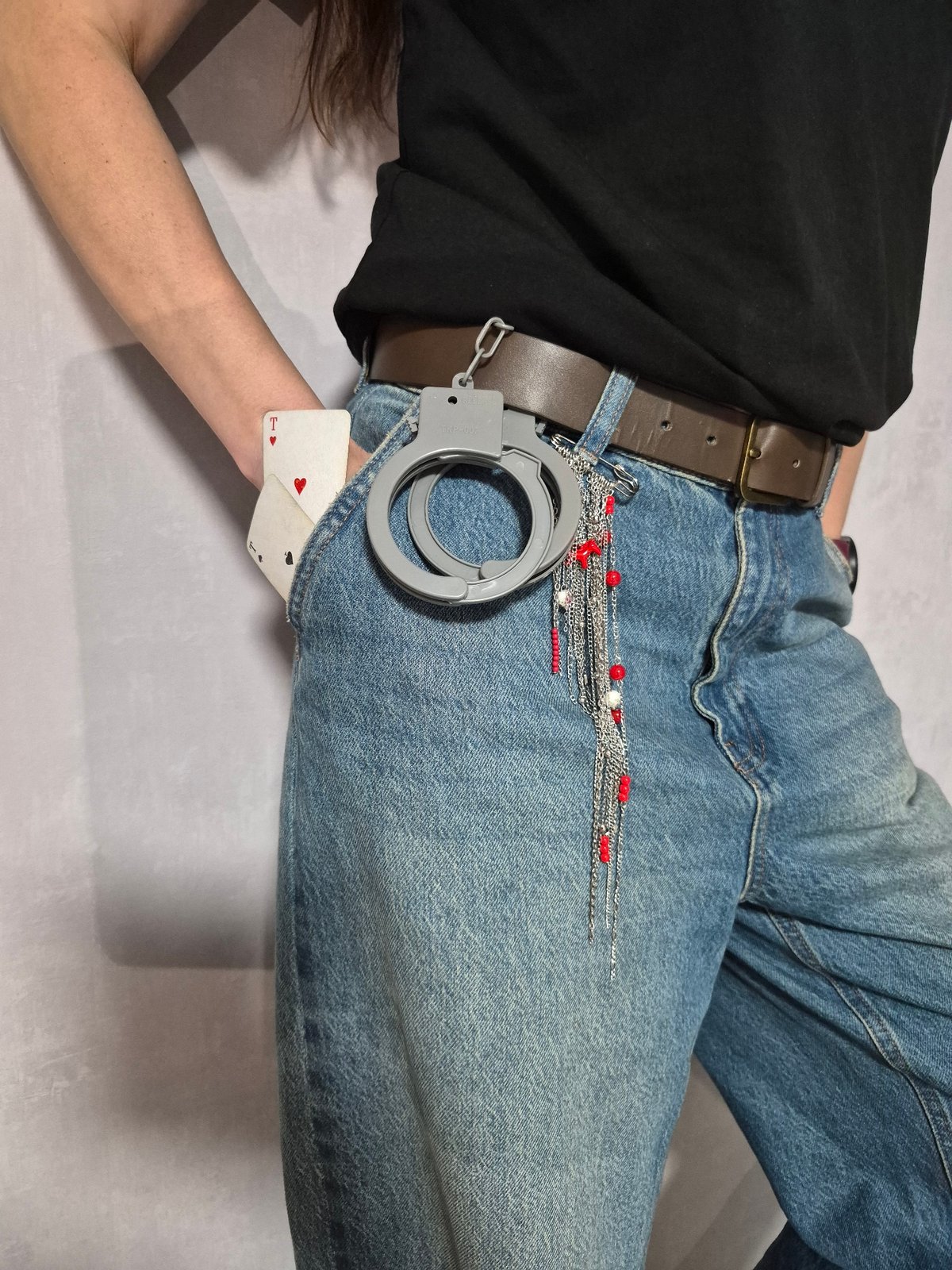 Person documents belongings, cards, handcuffs during casual pizza meal