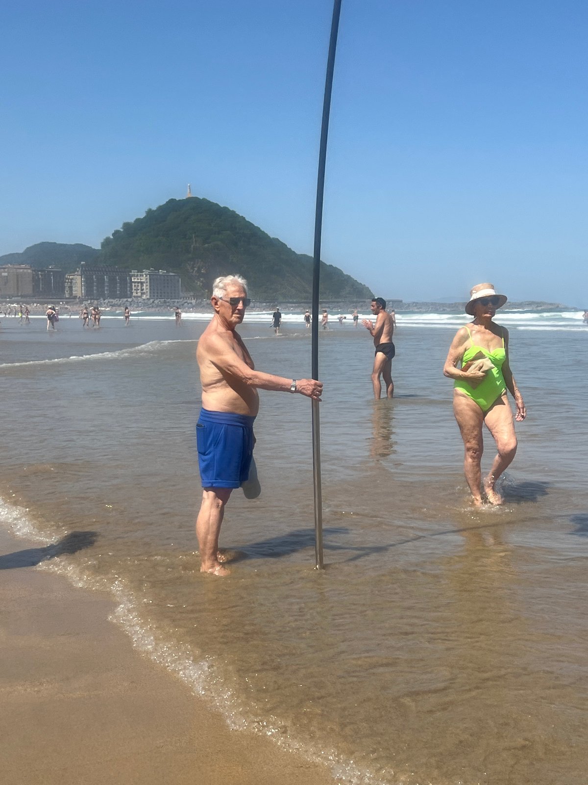 Lifeguard patrol and beachgoers at La Concha beach morning
