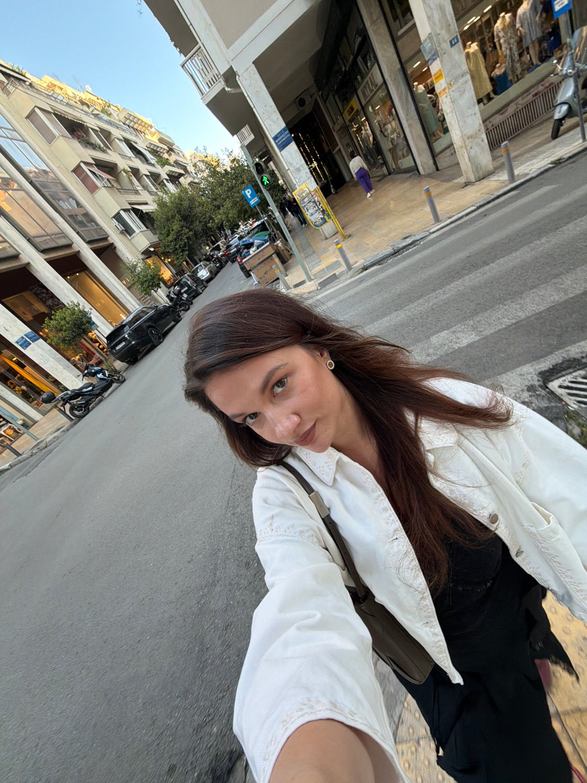 Woman documents Athens street walk with selfie