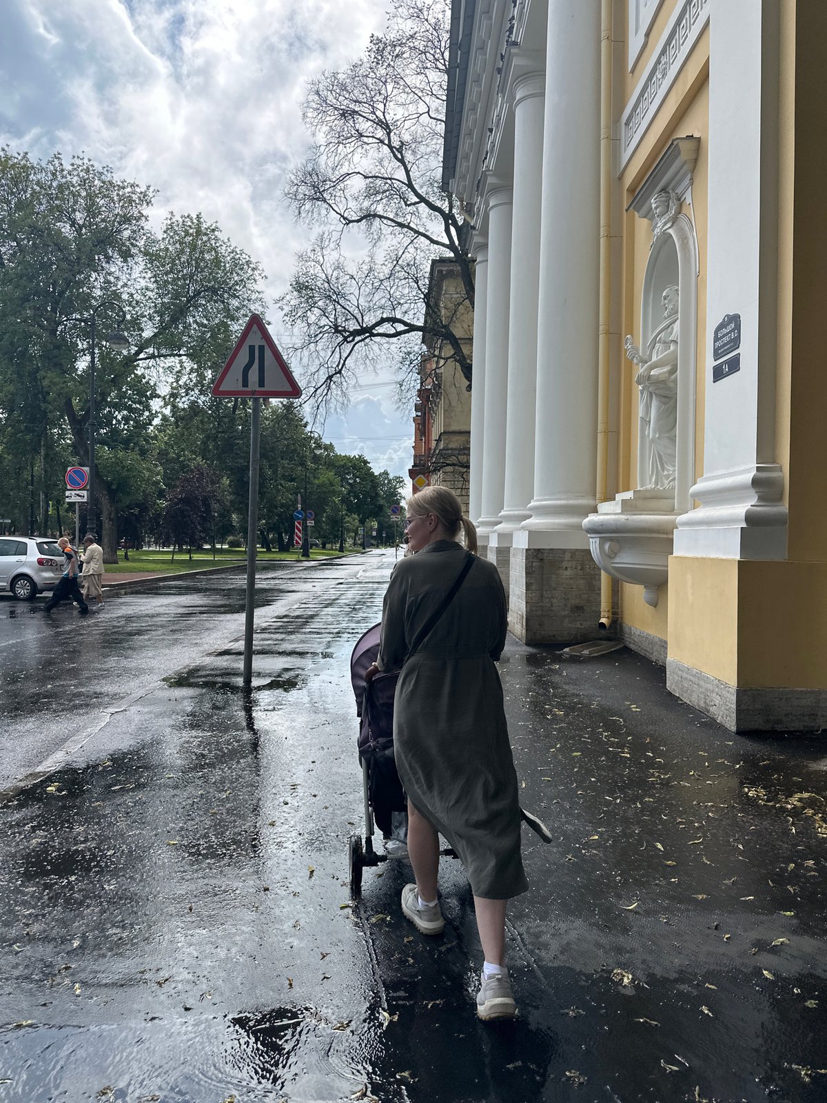 Wet streets and a stroller near Saint Petersburg's neoclassical architecture