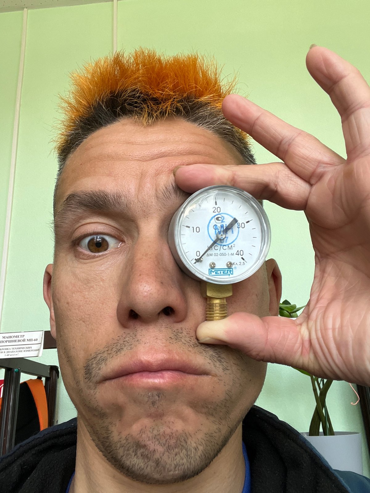 Person examines pressure gauge, wears decorated Crocs in Chaikovsky