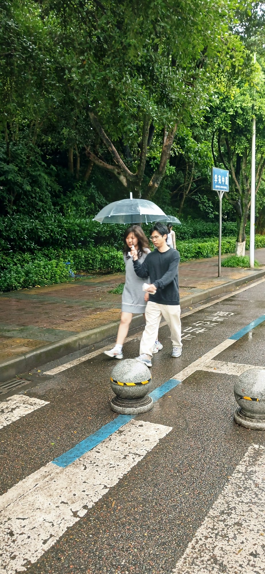Couple walks with clear umbrella during nighttime rain in Chongqing