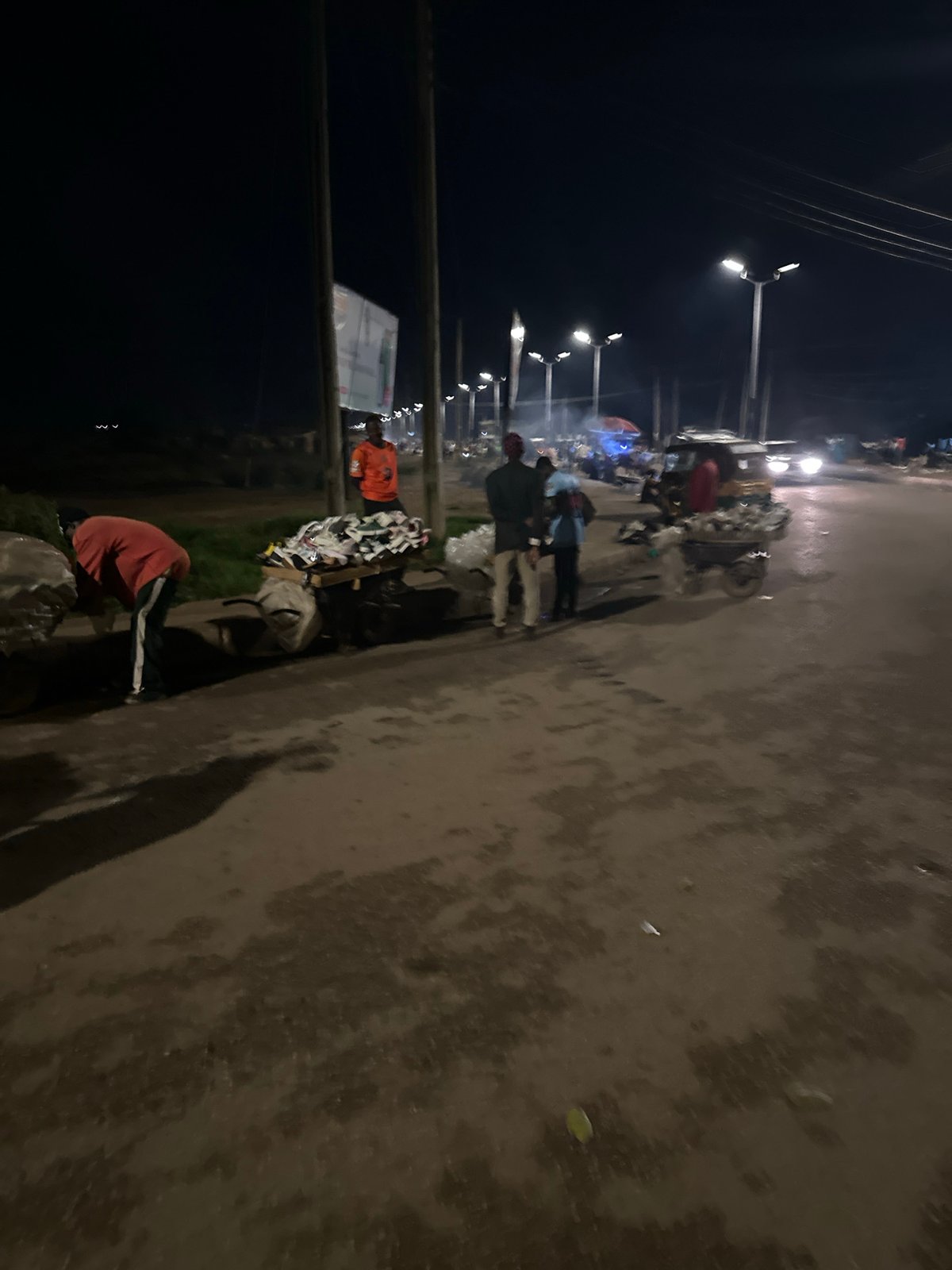 Bukuru night market in full swing, vendors and street traffic
